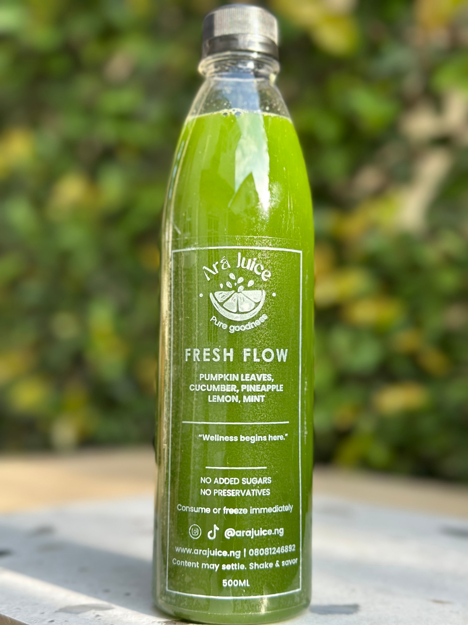 Pumpkin leaf Green juice bottle with a label on a blurred natural background