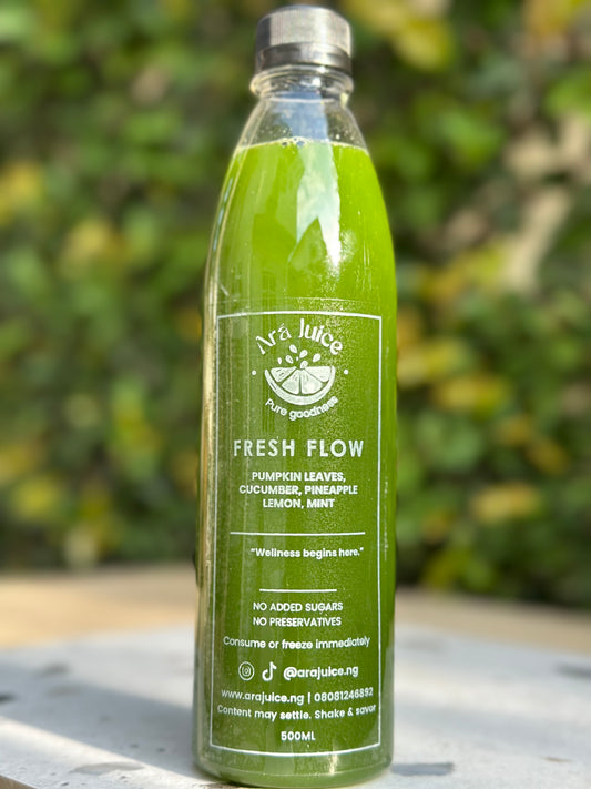 Pumpkin leaf Green juice bottle with a label on a blurred natural background